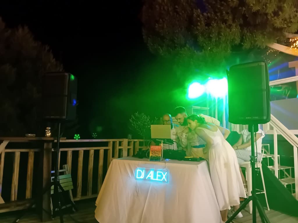 DJ Alex with headphones at luxury villa outdoor setup